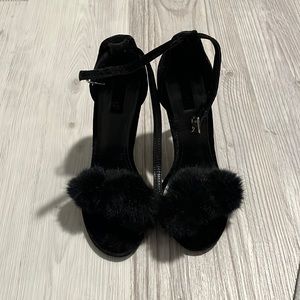 Black heels with pompoms